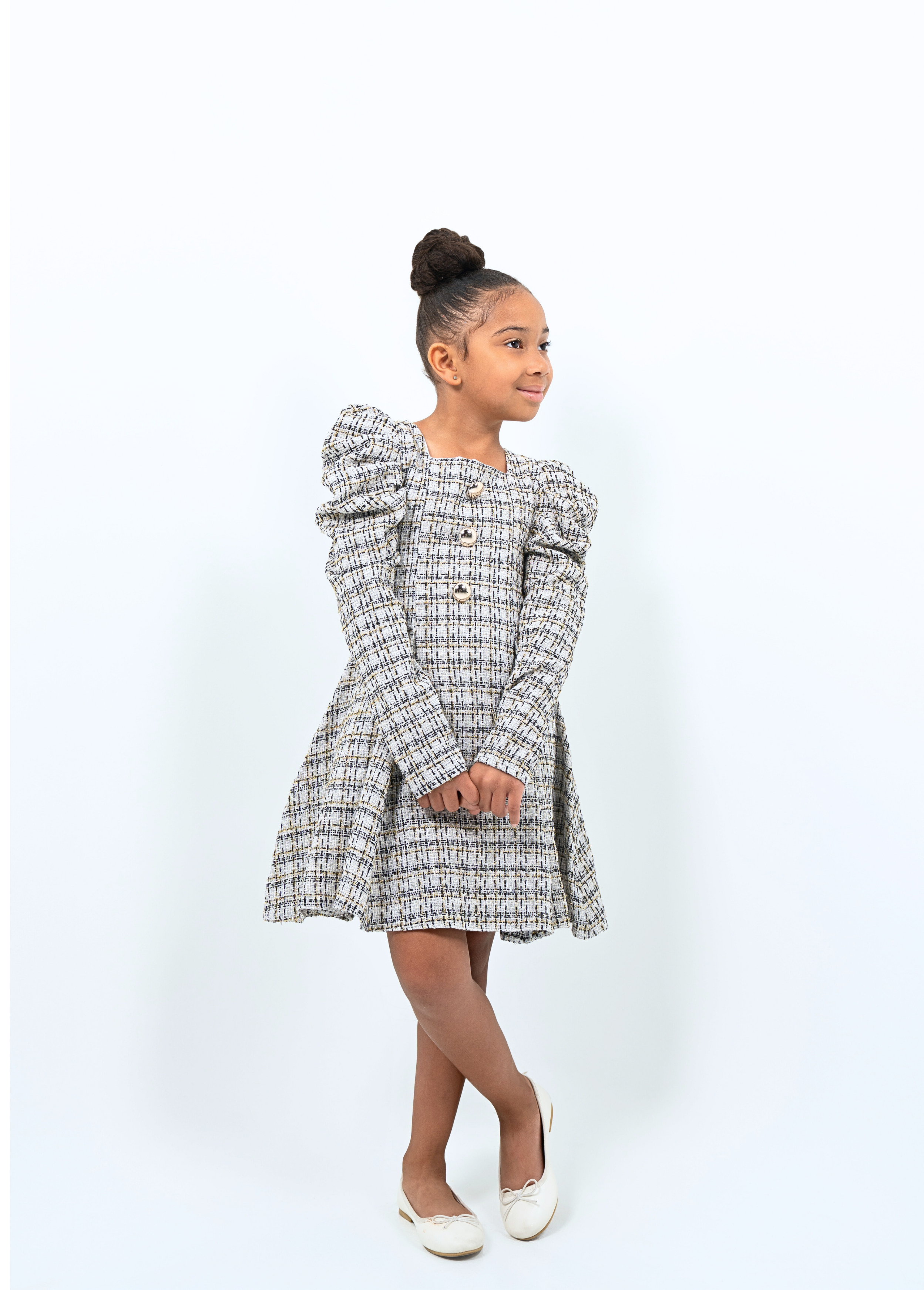 Girl wearing tweed puff sleeve coat dress with gold buttons, ideal for holidays or special events